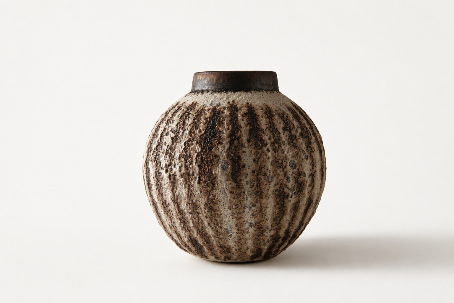 Rounded Moon Jar with a richly textured brown and cream volcanic surface