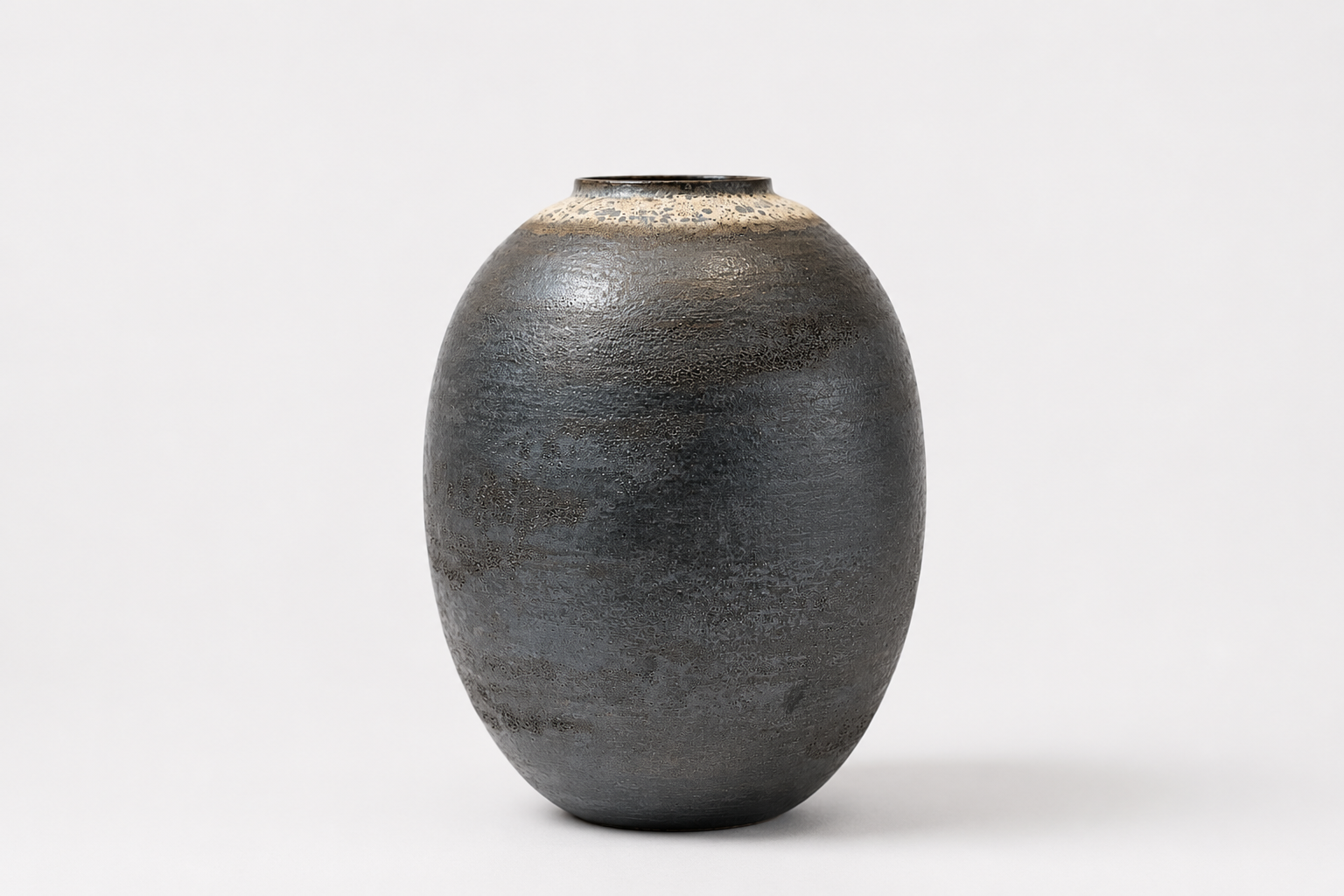 Tall dark Moon Jar with a restrained textured surface