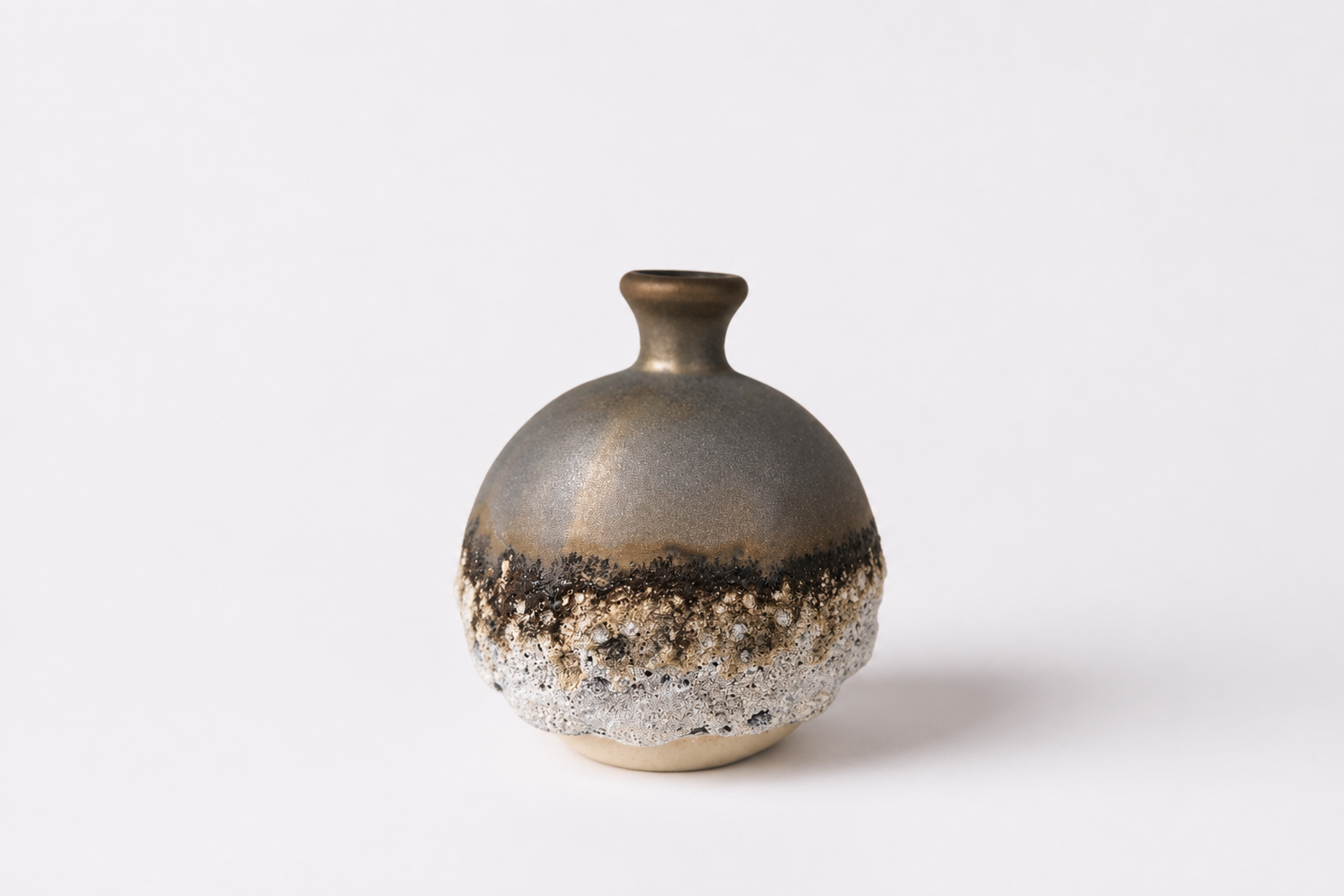 Rounded ceramic bottle with metallic grey and textured white surfaces