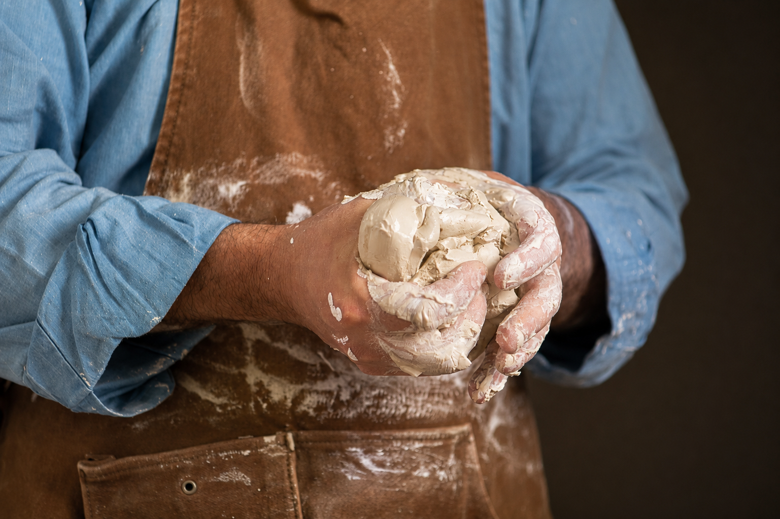 José preparing a piece of clay between his hands