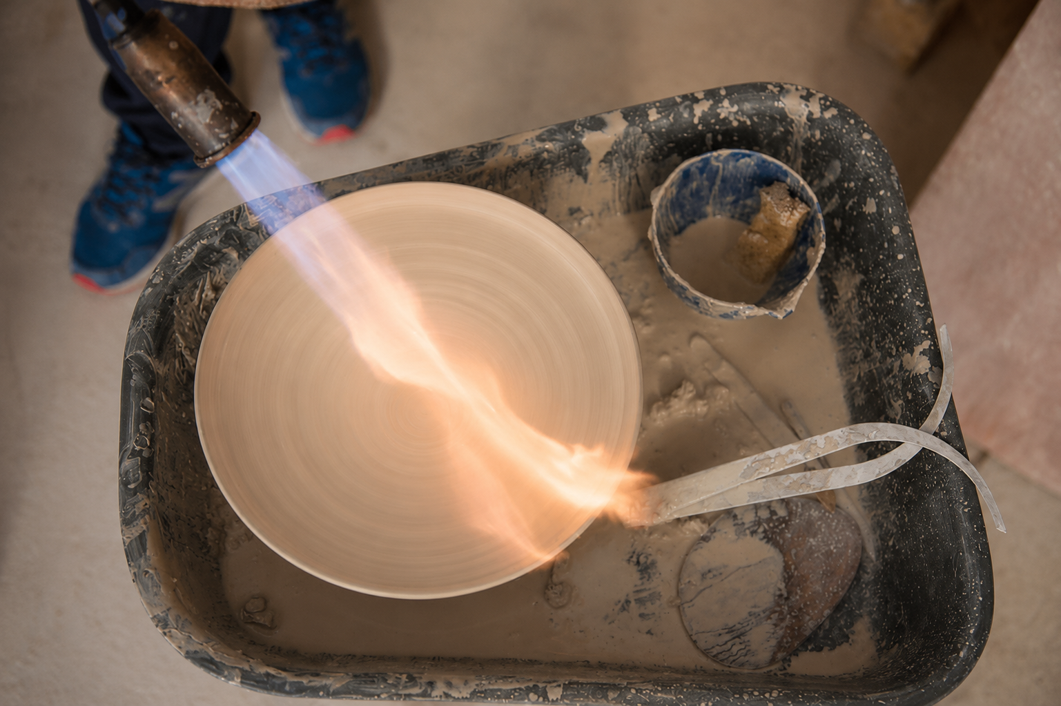 A flame passing across a ceramic bowl during the making process