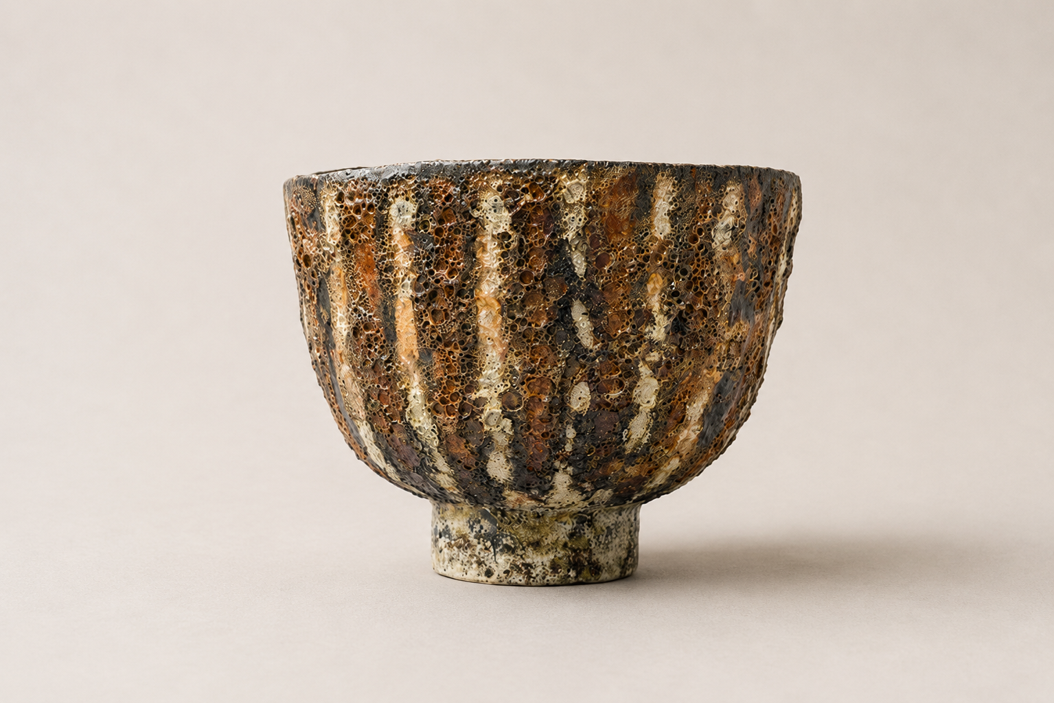 Deep V-shaped vessel with layered brown, black and cream glazes