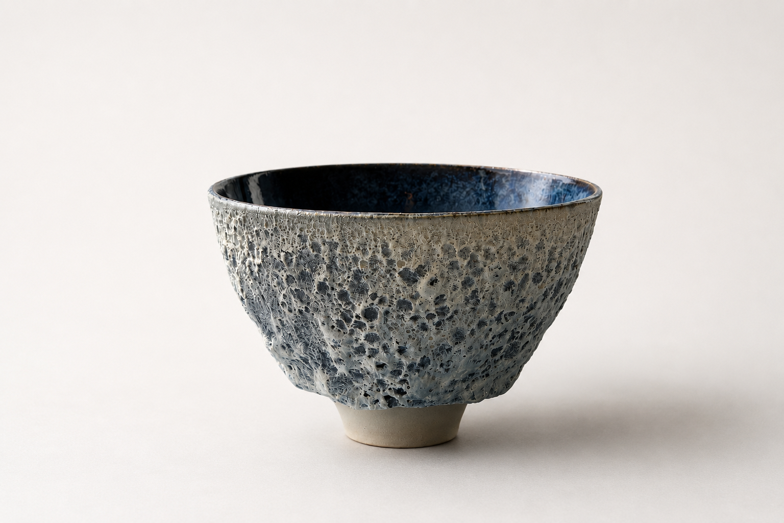 Grey and cream V-shaped vessel with a dark blue interior