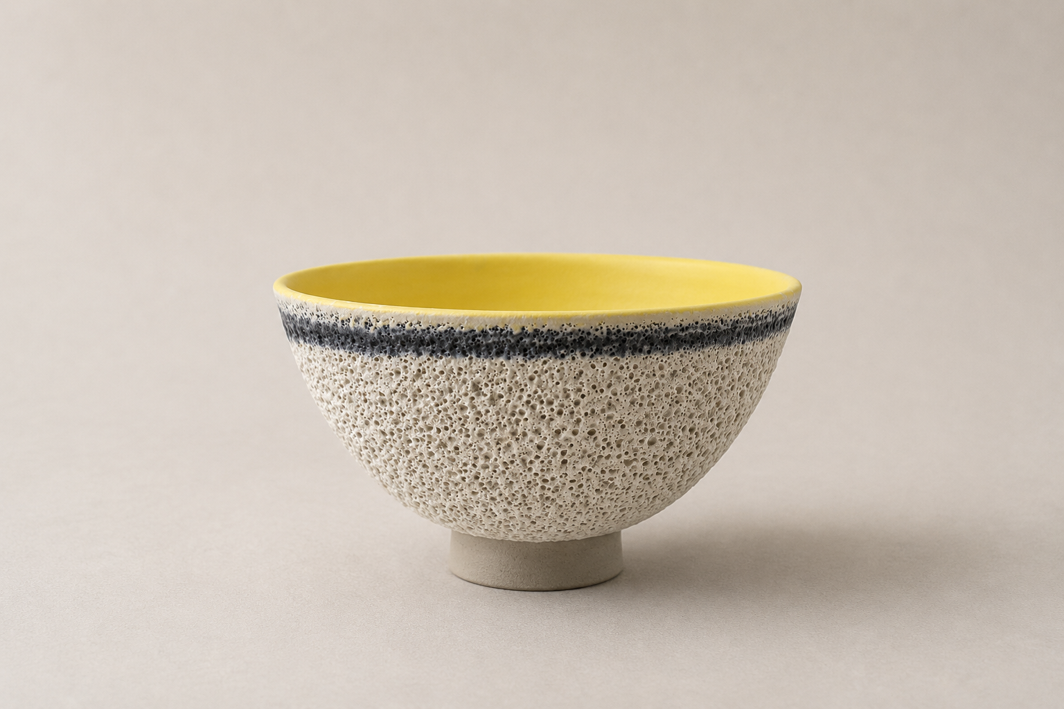 V-shaped vessel with a yellow interior and pale textured exterior